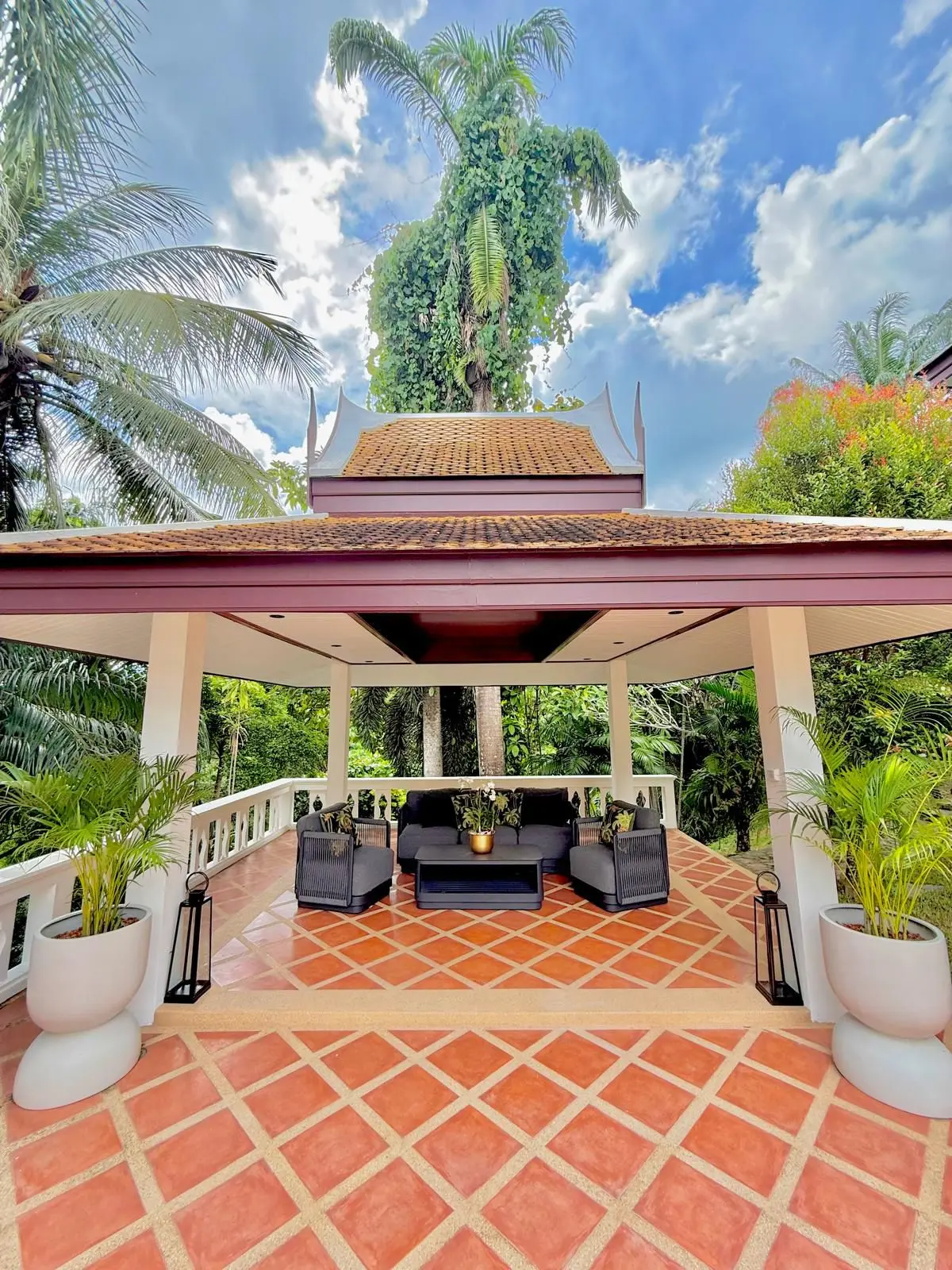 Outdoor sala pavilion entrance with hand-carved gable