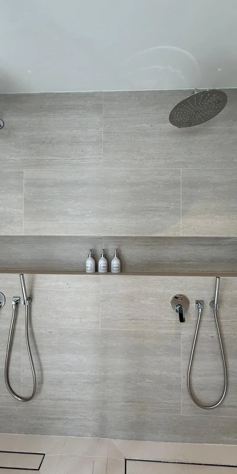 Master bathroom twin rainfall showers — his and hers configuration