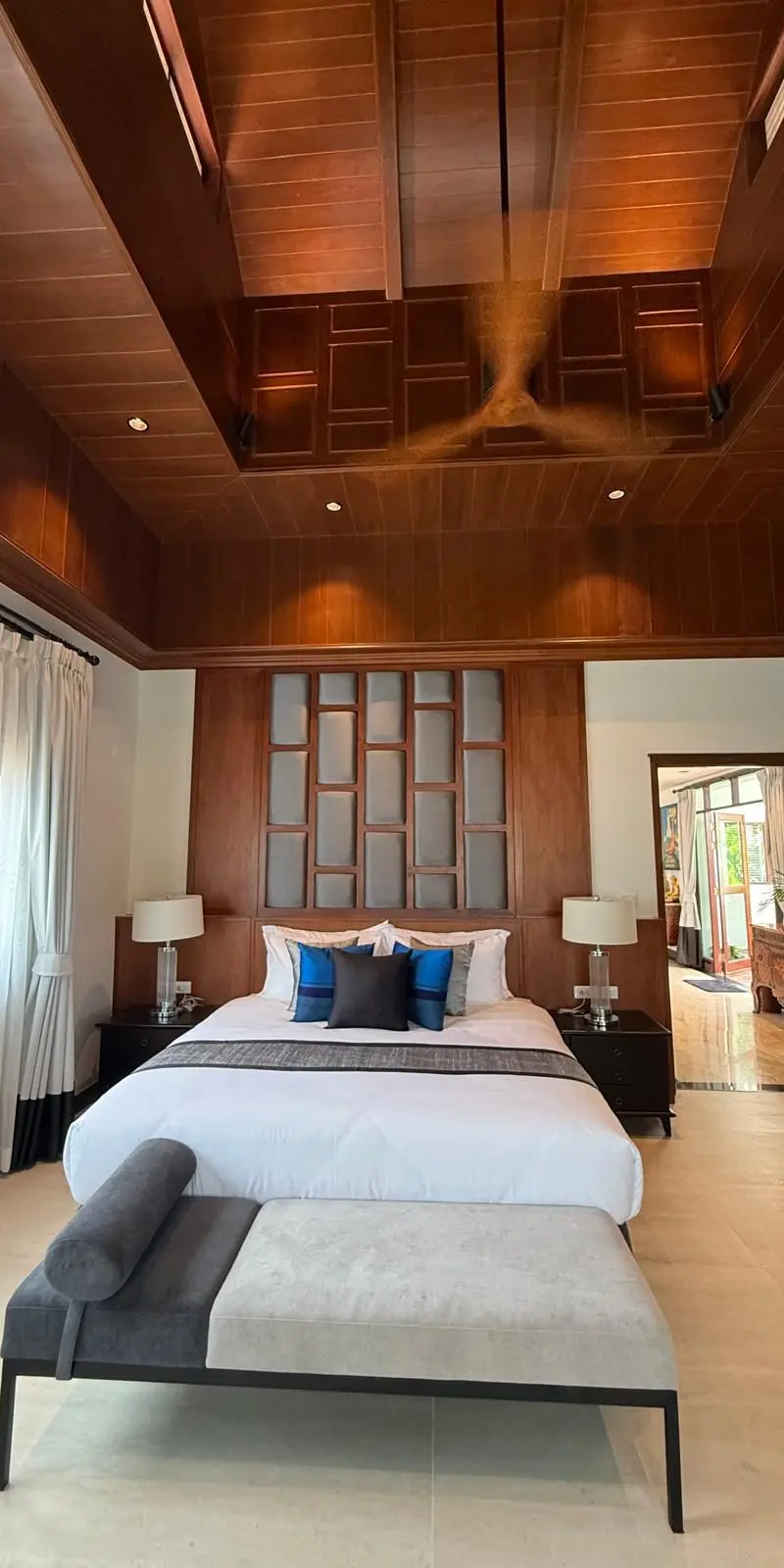 Guest bedroom with lattice-panel headboard and blue accent cushions