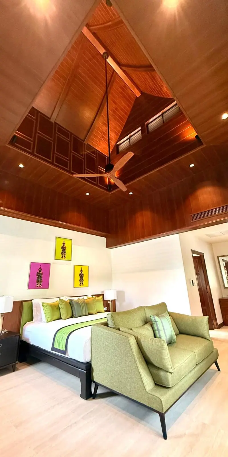 Bedroom view with sitting bench and Thai puppet art trio