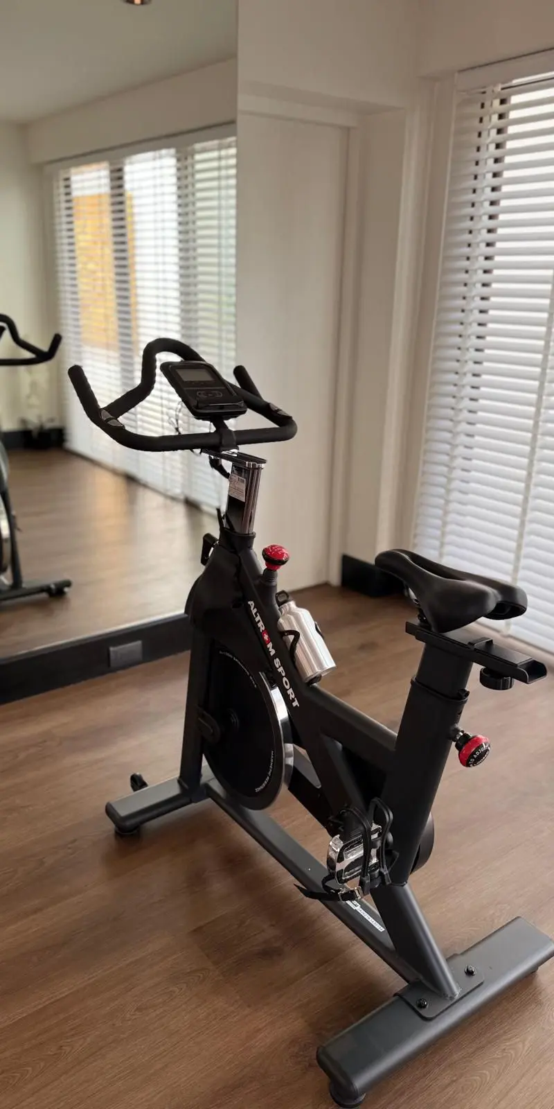 Home gym with Wattbike studio bike and full mirror wall