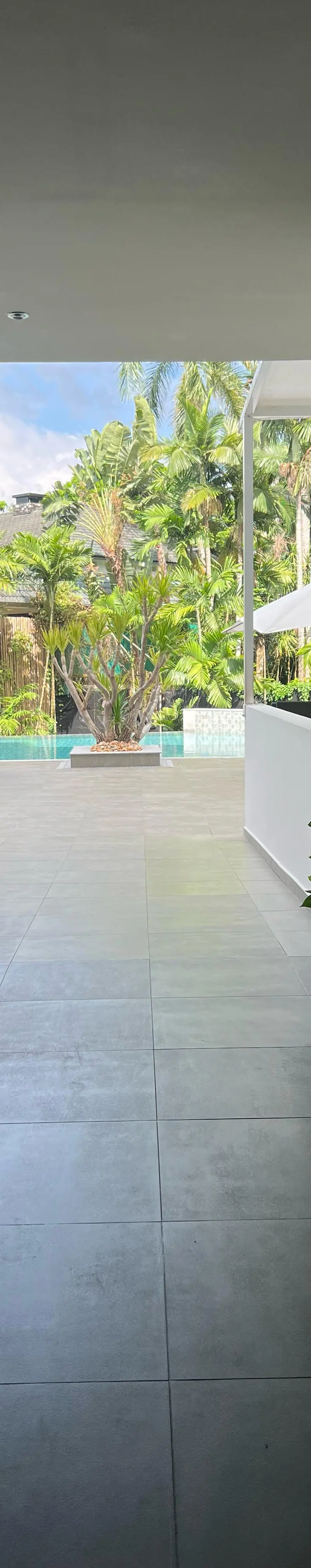 Open-air lobby corridor leading to the pool deck
