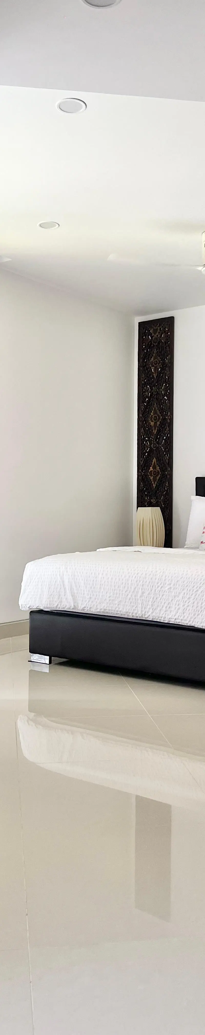 Master bedroom with floor-to-ceiling windows and corner reading chair