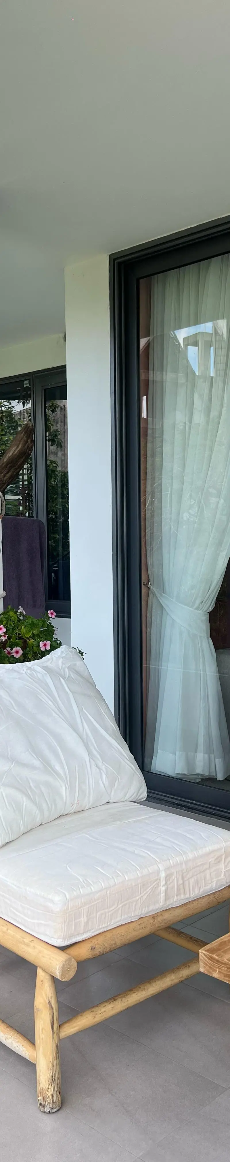 Balcony detail with elephant ear plant and view to pool