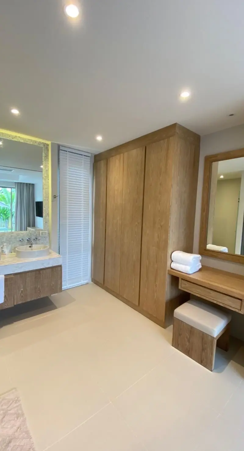 Master bathroom with double vanity, walk-in closet and dressing desk