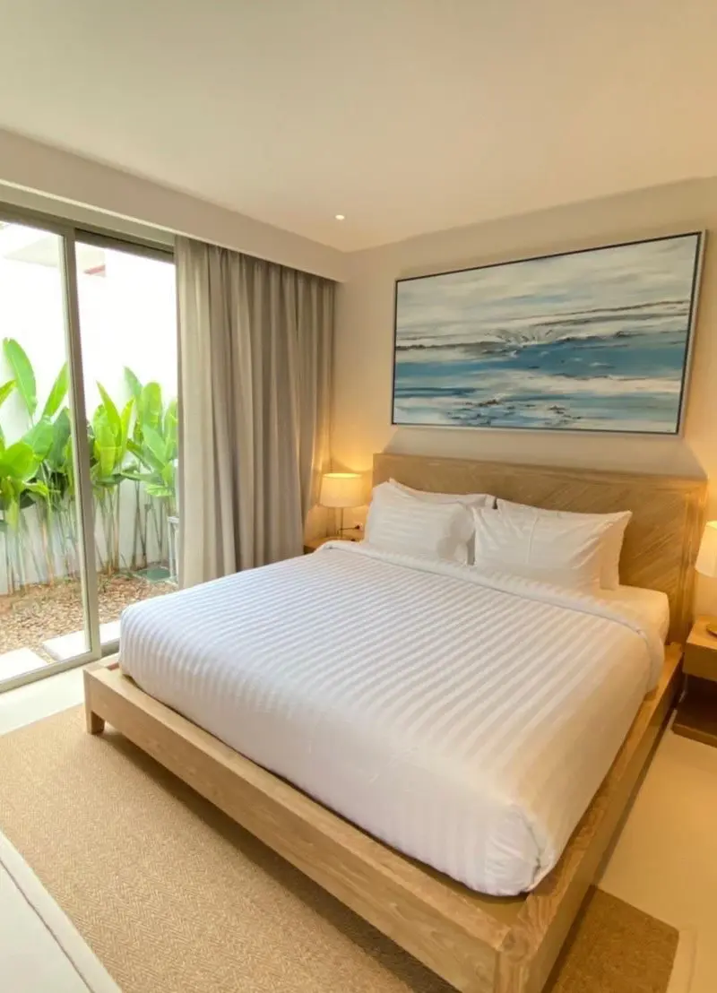 Guest bedroom with sliding door to private banana-plant garden patio