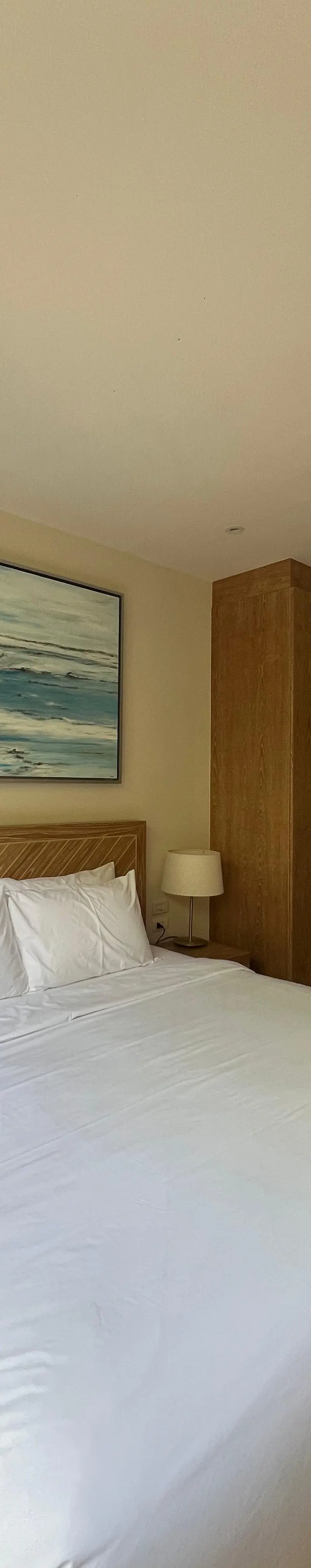 Guest bedroom — ocean wave art, sliding door garden view