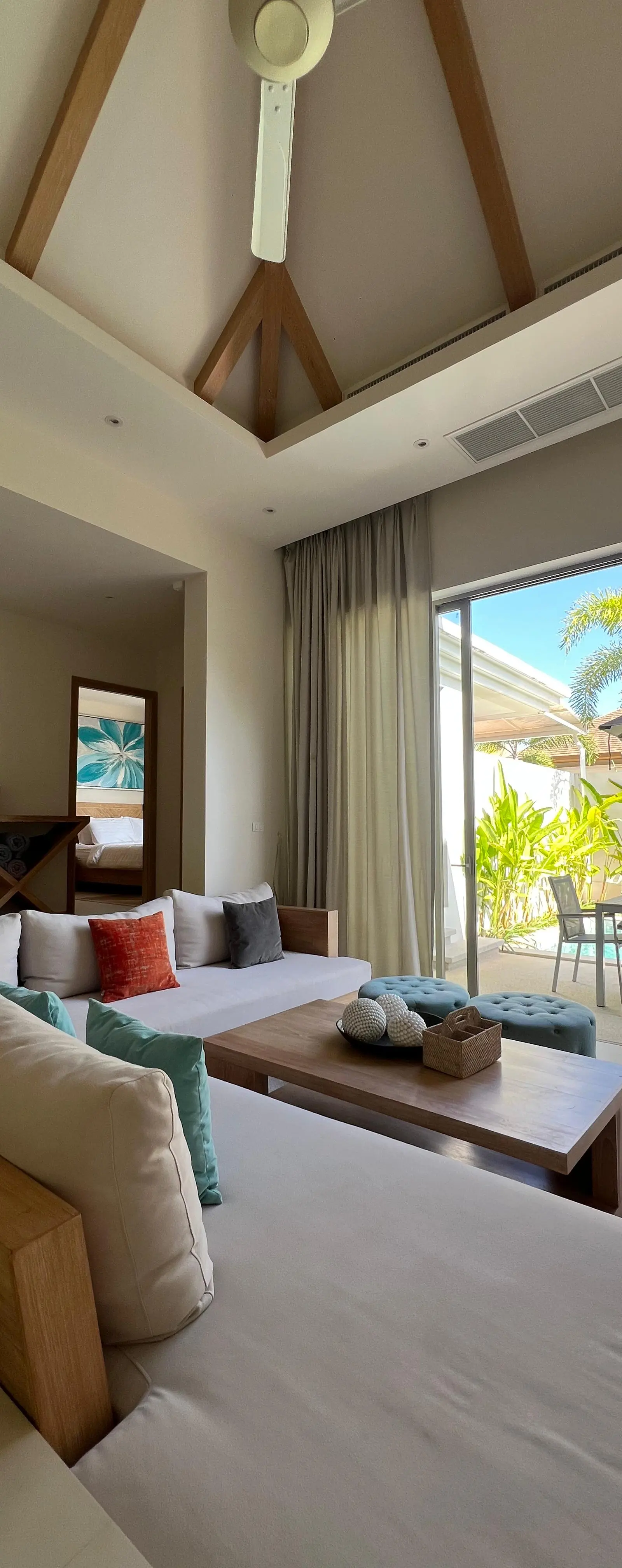 Living room view from the kitchen — opens to bedroom and pool